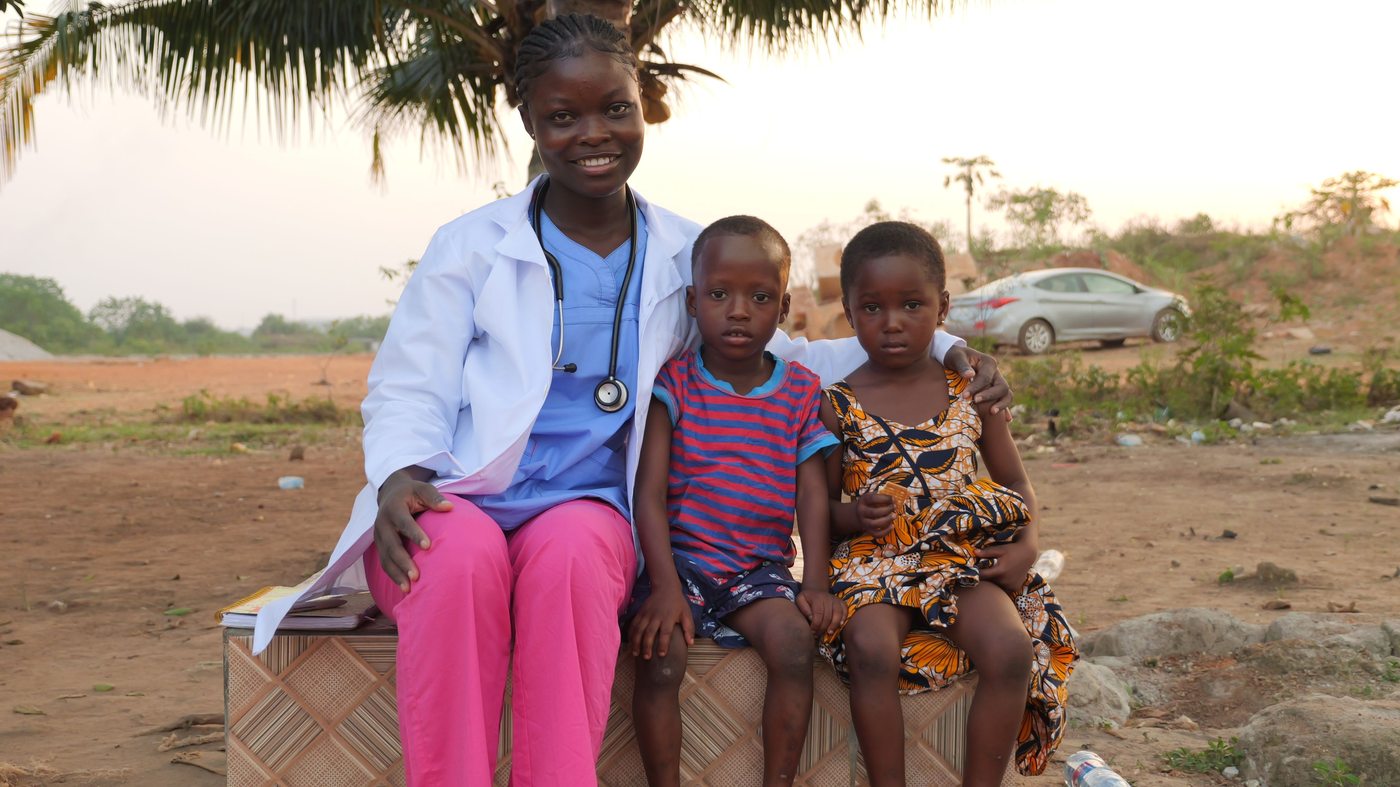 A health worker with children in a community setting