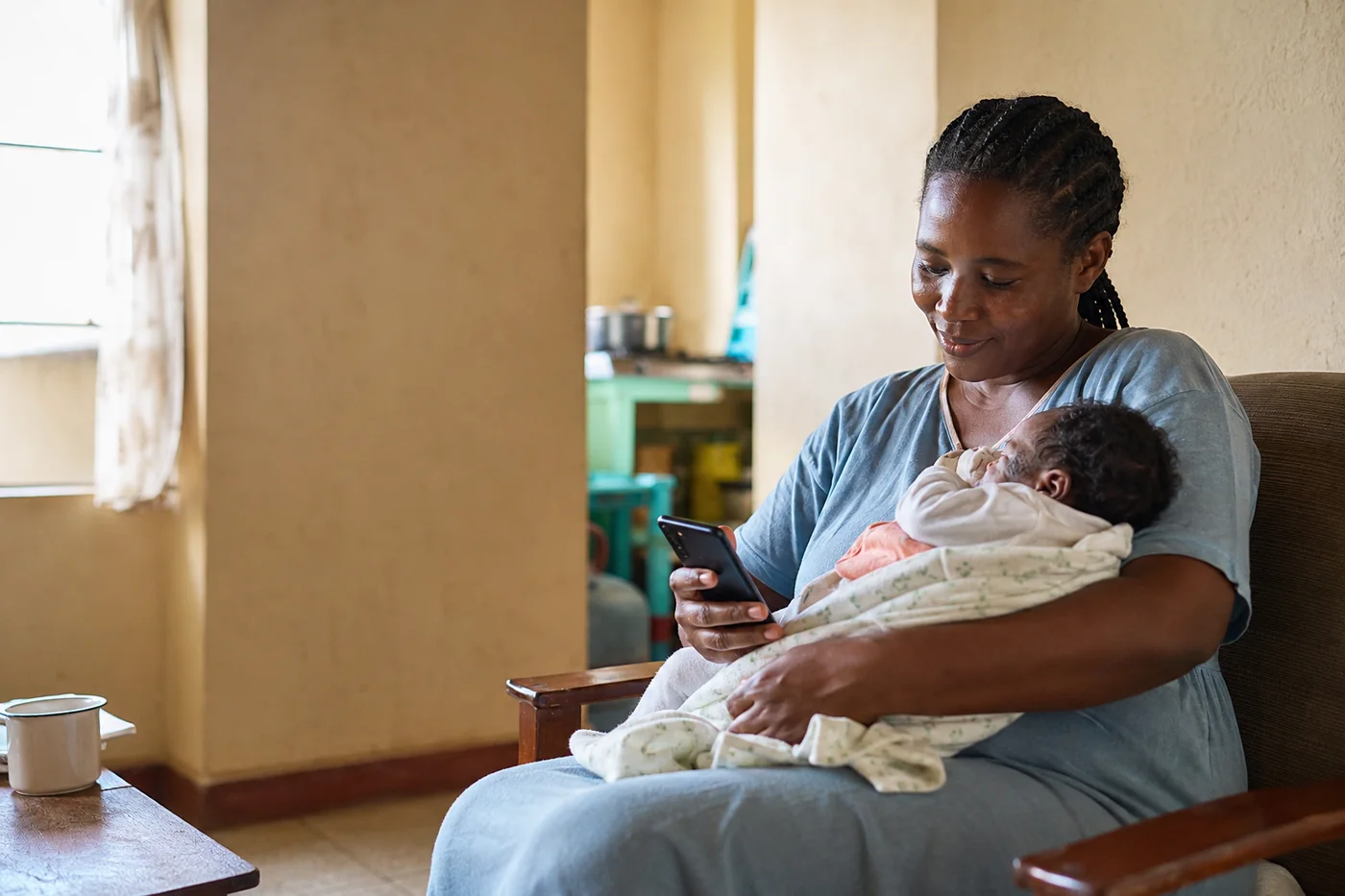 A caregiver at home with her baby